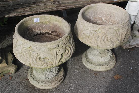 Pair stone urns on stands(-)